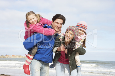 Family Walking Along Winter Beach