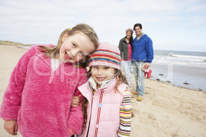 Family Walking Along Winter Beach