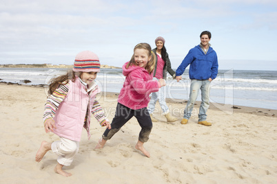 Family Walking Along Winter Beach