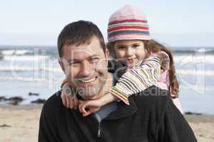 Father And Daughter Having Fun On Beach Together