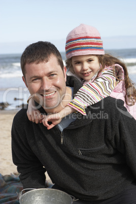 Father And Daughter Having Fun On Beach Together