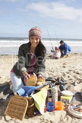 Family Having Picnic On Winter Beach