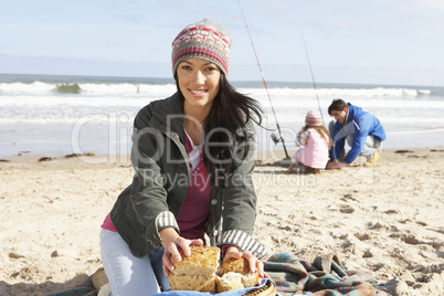 Family Having Picnic On Winter Beach