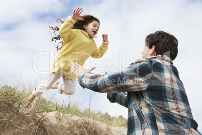 Father And Daughter Having Fun On Beach Together