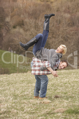 Portrait Of Energetic Young Couple Having Fun