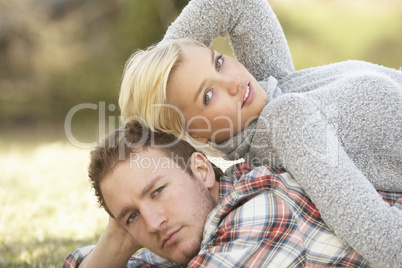 Portrait Of Romantic Young Lying On Grass