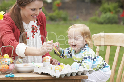 Mother And Daughter Painting Easter Eggs In Gardens