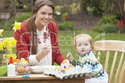 Mother And Daughter Painting Easter Eggs In Gardens