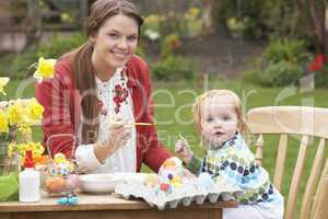 Mother And Daughter Painting Easter Eggs In Gardens