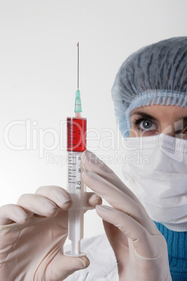 Medicine doctor with medical syringe in hands