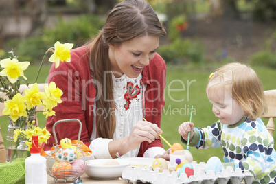 Mother And Daughter Painting Easter Eggs In Gardens