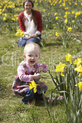 Mother And Daughter In Daffodil Field With Decorated Easter Eggs