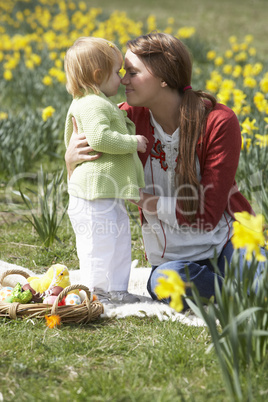 Mother And Daughter In Daffodil Field With Decorated Easter Eggs