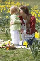 Mother And Daughter In Daffodil Field With Decorated Easter Eggs