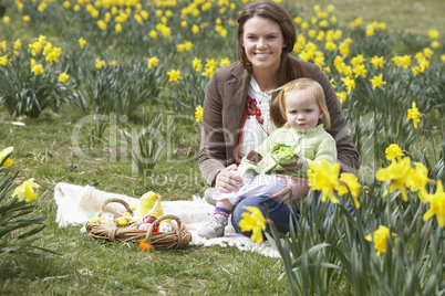 Mother And Daughter In Daffodil Field With Decorated Easter Eggs