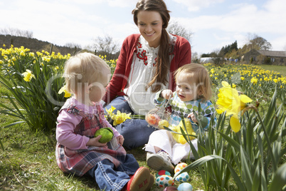 Mother And Daughter In Daffodil Field With Decorated Easter Eggs
