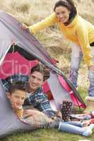 Young Family Relaxing Inside Tent On Camping Holiday