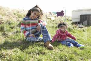 Young Girls Sitting Outside In Caravan Park