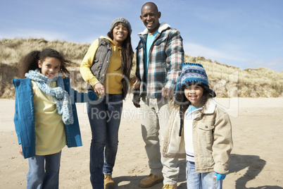 Family Walking On Winter Beach
