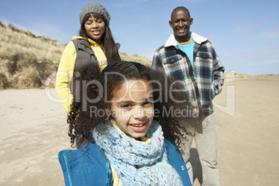 Family Wallking On Winter Beach