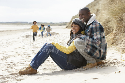 Family Having Fun On Winter Beach