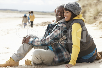 Family Having Fun On Winter Beach