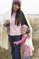 Mother And Daughter Wrapped In Blanket Amongst Dunes On Winter B