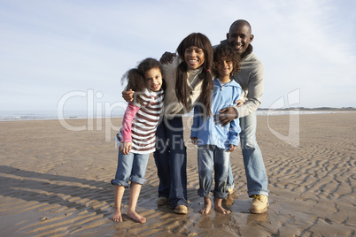 Family Walking On Winter Beach