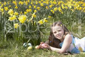 Girl On Easter Egg Hunt In Daffodil Field