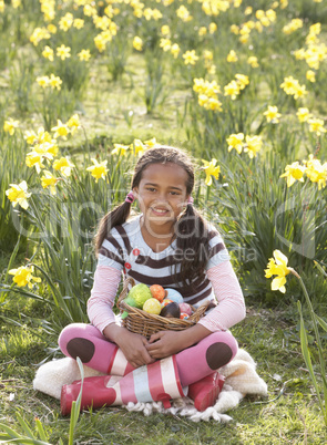 Girl On Easter Egg Hunt In Daffodil Field