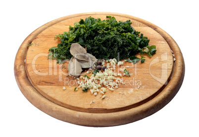 Fennel, parsley, garlic, bay leaf on the chopping board