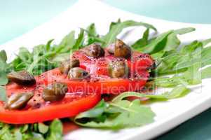 Salad with fresh tomatoes, capers and arugula