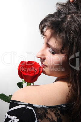 Beautiful young girl with a red rose