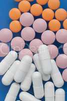 White, pink and orange pills