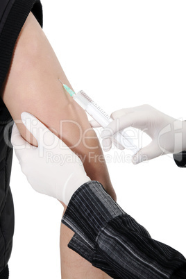 Doctor giving an injection to a young female in the doctors offi