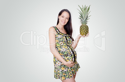 pregnant woman holding pinapple