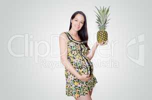 pregnant woman holding pinapple