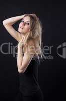 Young beauty blond girl in black dress look at you