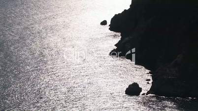 Silhouette of a rocky shore.
