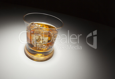 Glass of Whiskey and Ice Under Spot Light