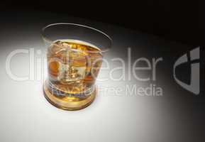 Glass of Whiskey and Ice Under Spot Light