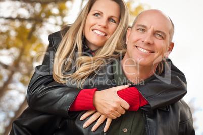 Attractive Couple in Park with Leather Jackets