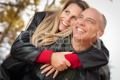 Attractive Couple in Park with Leather Jackets