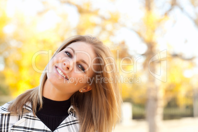 Pretty Young Woman Smiling in the Park