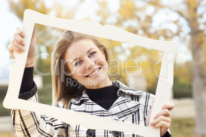 Pretty Young Woman Smiling in the Park with Picture Frame