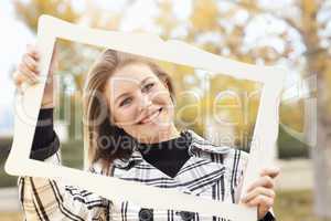 Pretty Young Woman Smiling in the Park with Picture Frame