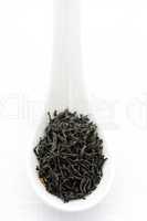 Dry black tea leaves in a spoon