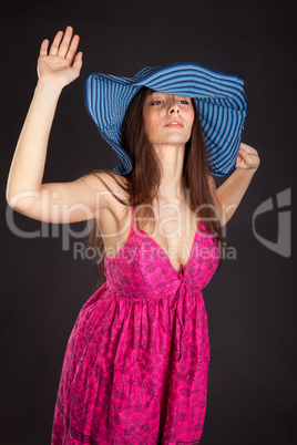 Pretty young girl in red dress posing in studio