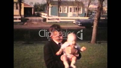 Proud Parents Holding Baby Outdoors (1963 - Vintage 8mm film)