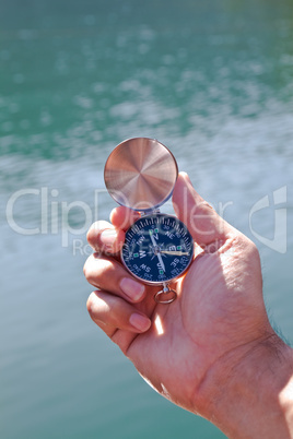 Hand holding the black compass